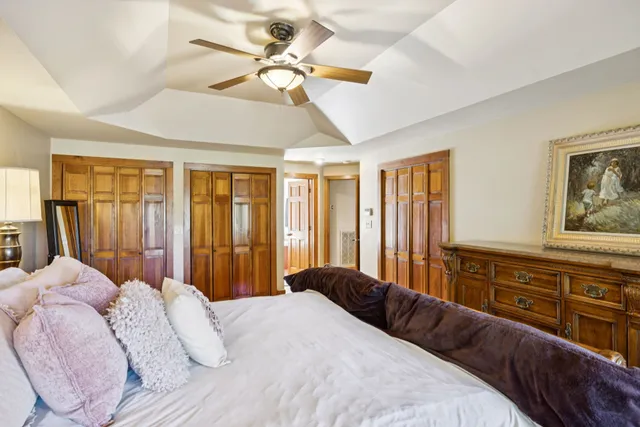 a bedroom with a bed and a chandelier