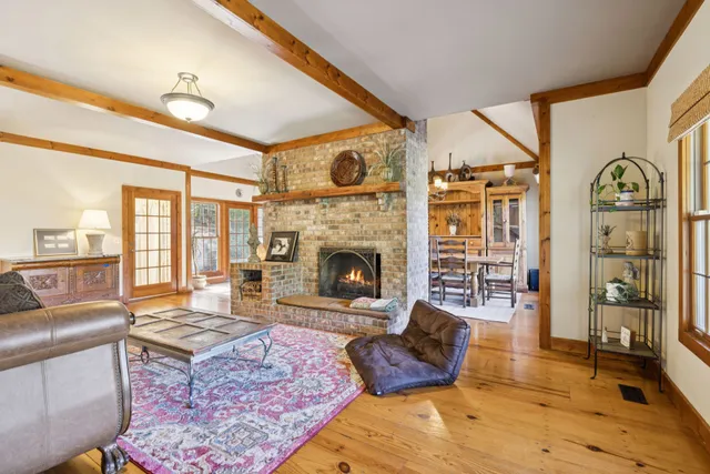 a living room with furniture rug and window