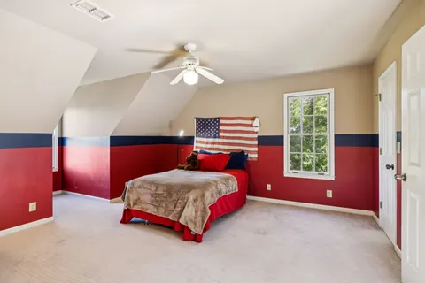 a bedroom with a bed and a chandelier