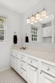 a bathroom with a sink a toilet and a mirror