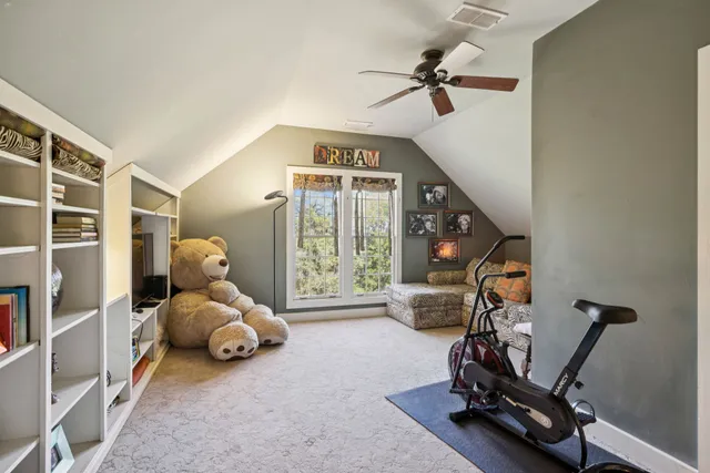 a living room with furniture and flowers
