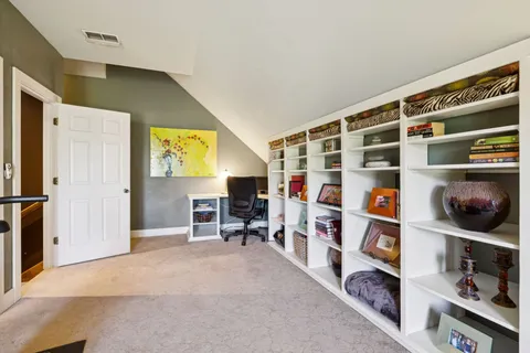 a living room with furniture and flowers
