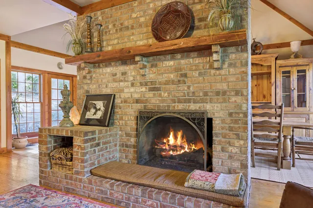 a view of a dining room with furniture a chandelier and wooden floor