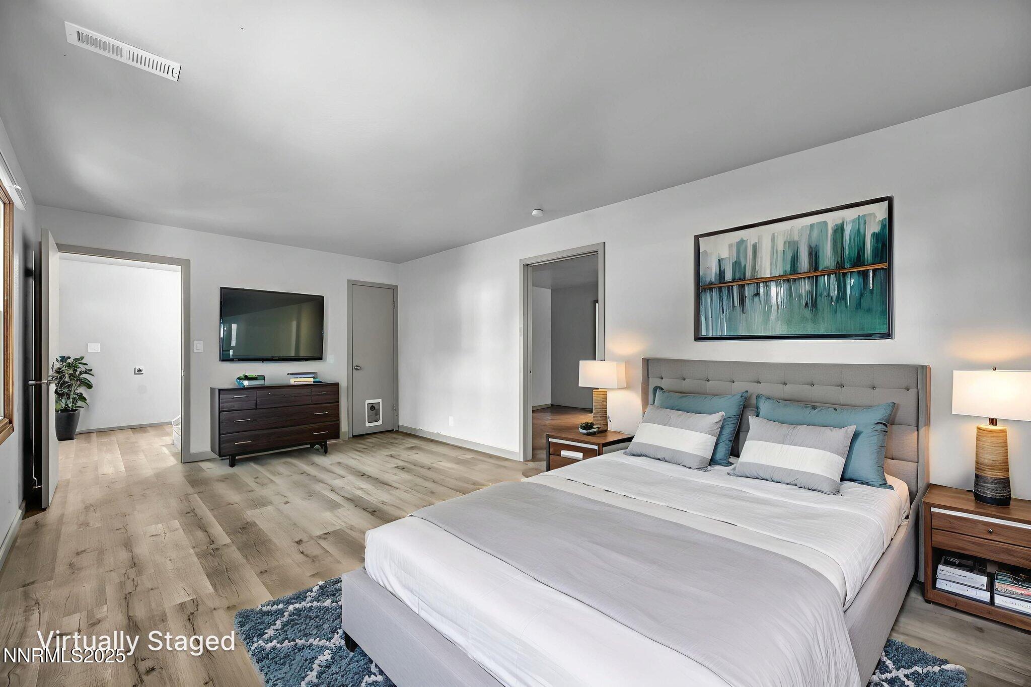 1478 Clough Road Reno, NV 89509 - Photo 13 of 32 a bedroom with a bed and a television