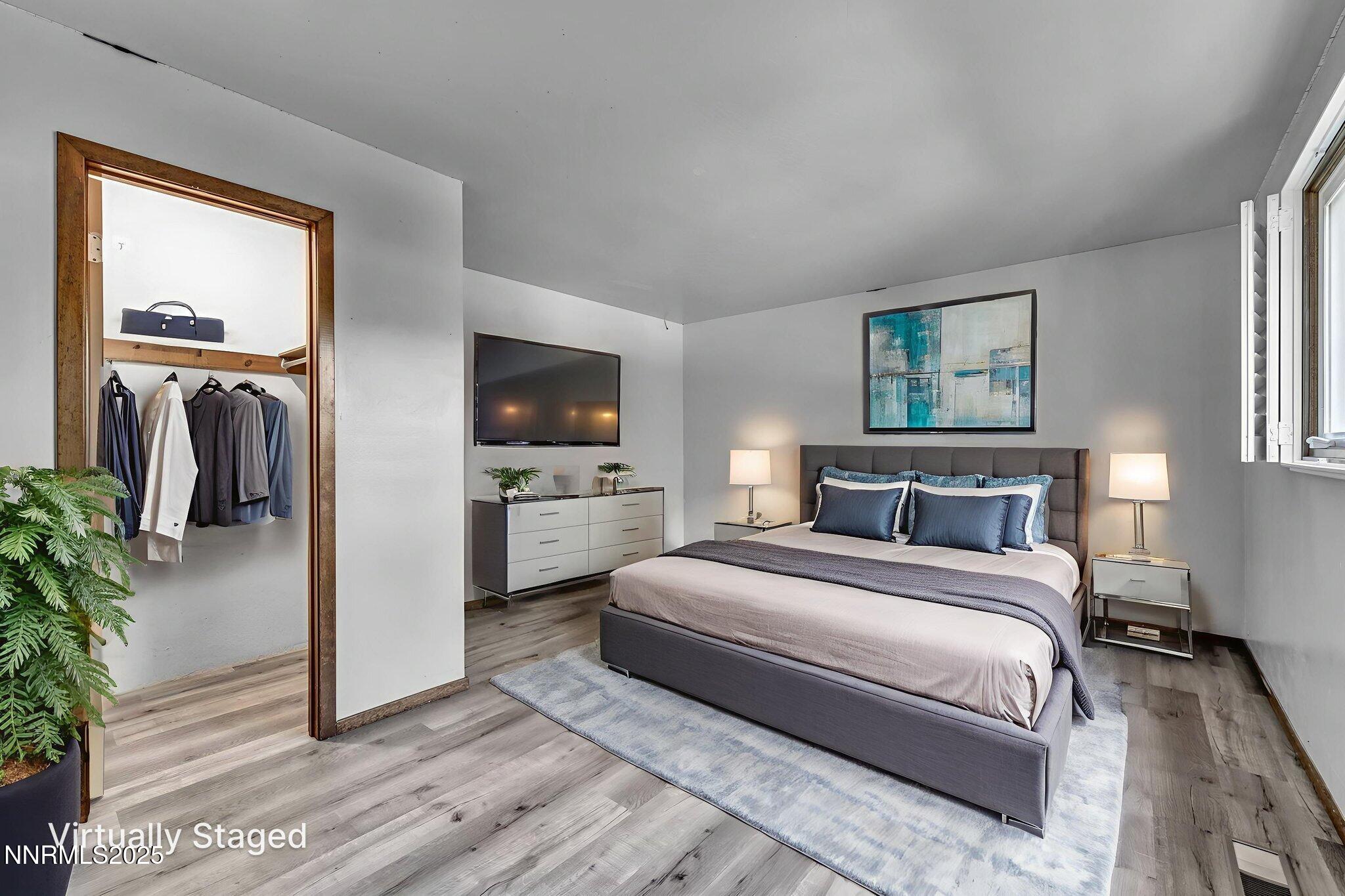 1478 Clough Road Reno, NV 89509 - Photo 15 of 32 a bedroom with a bed and a flat screen tv