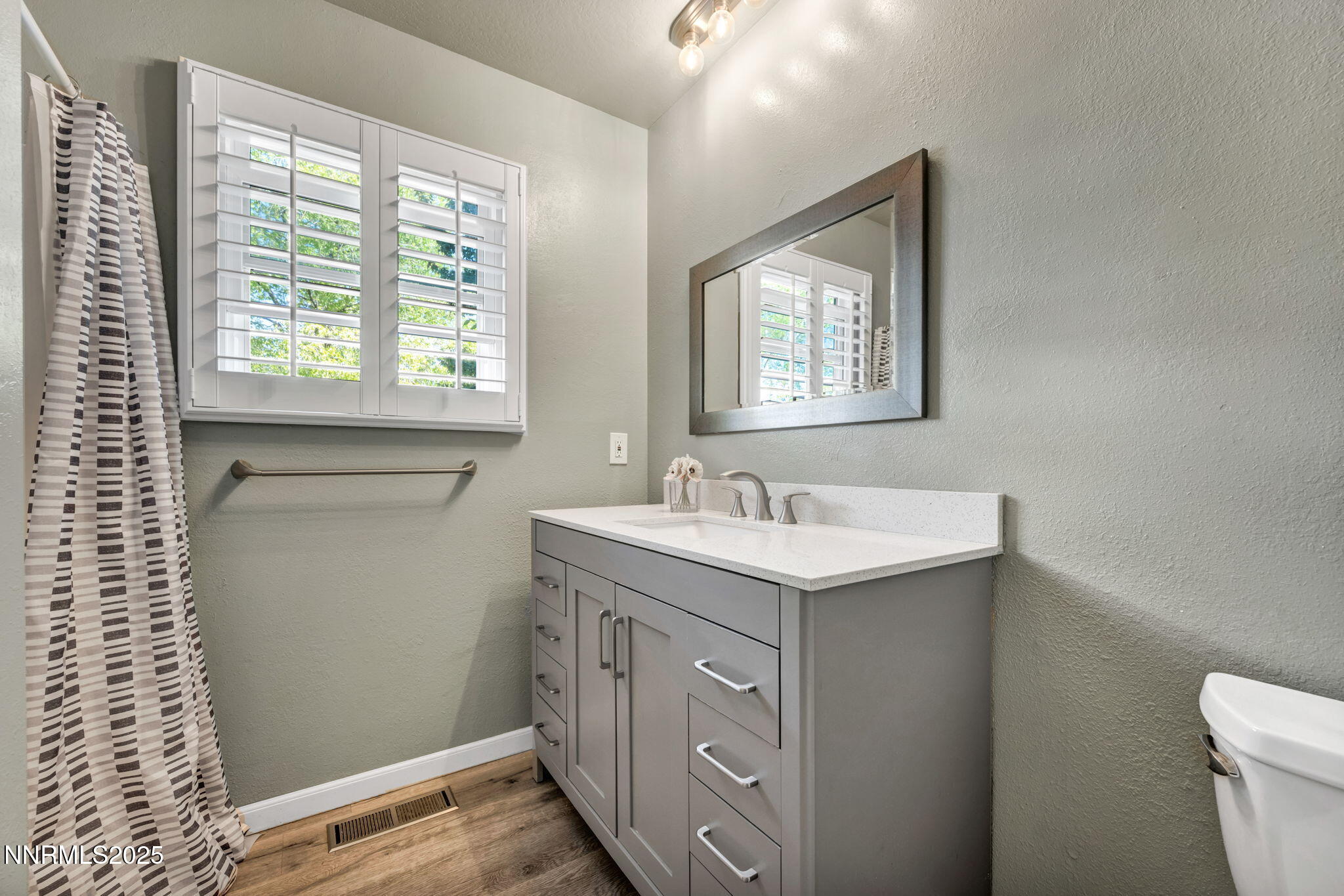 1478 Clough Road Reno, NV 89509 - Photo 16 of 32 a bathroom with a granite countertop sink mirror and a toilet