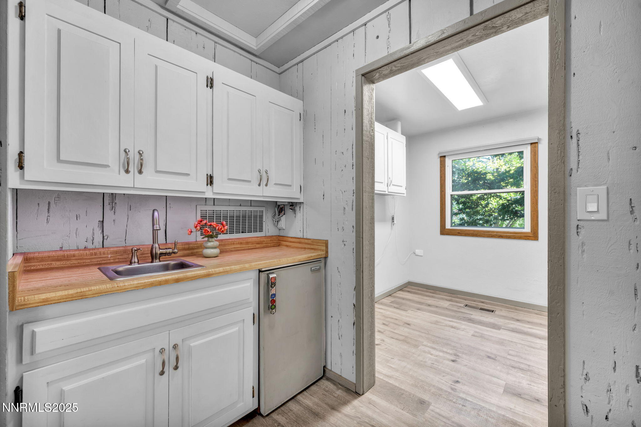 1478 Clough Road Reno, NV 89509 - Photo 19 of 32 a utility room with stainless steel appliances granite countertop a sink window and cabinets