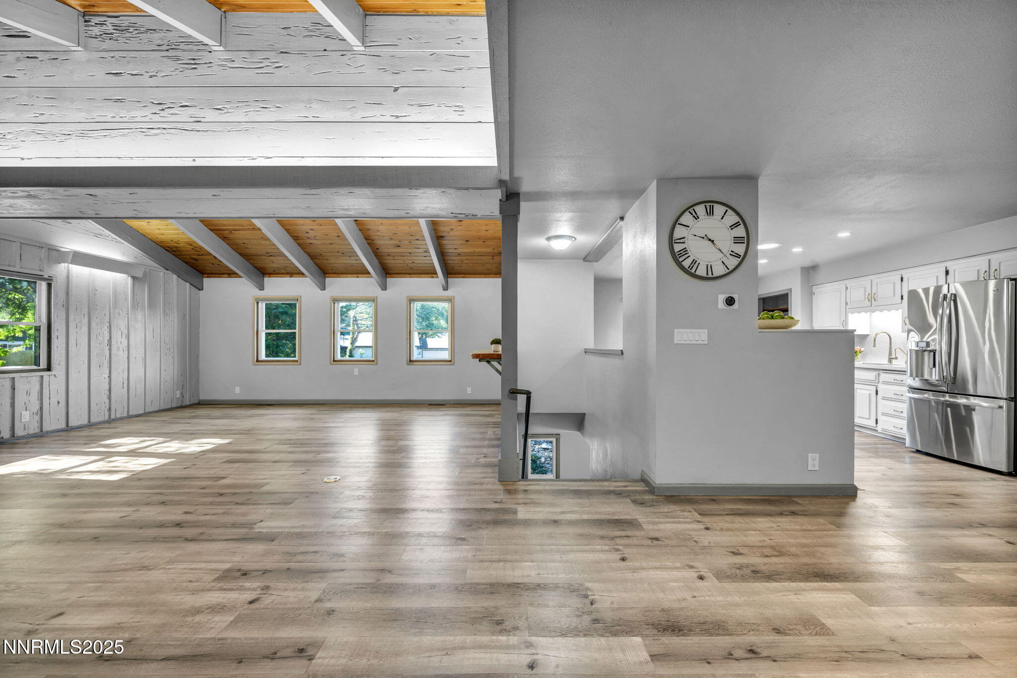 1478 Clough Road Reno, NV 89509 - Photo 9 of 32 an empty room with wooden floor and windows