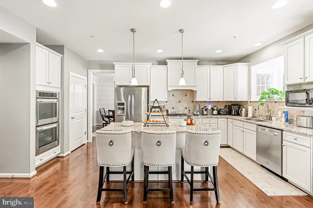 a kitchen with stainless steel appliances granite countertop a stove and cabinets