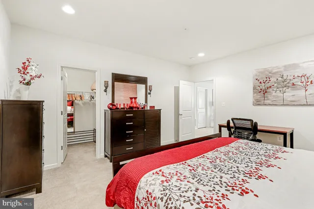 a bedroom with a large bed and a chandelier