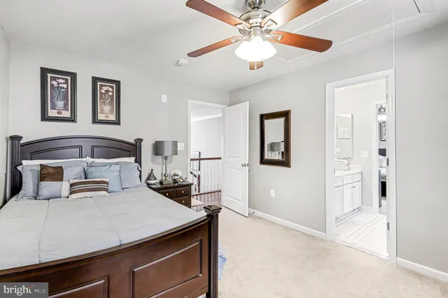 a bedroom with a bed and a flat tv screen on the dresser