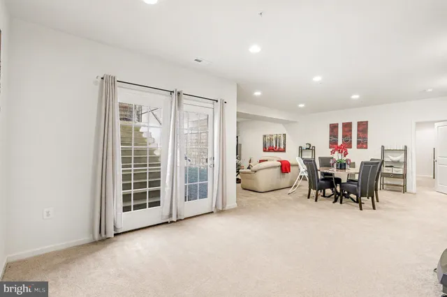 a view of a patio with couches table and chairs and potted plants