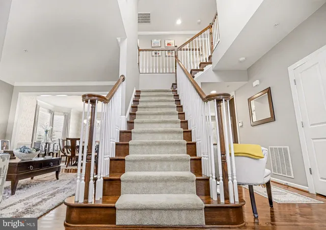 a view of a hallway with wooden floor and windows