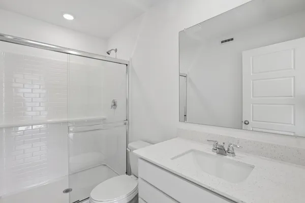 a bathroom with a sink toilet and shower