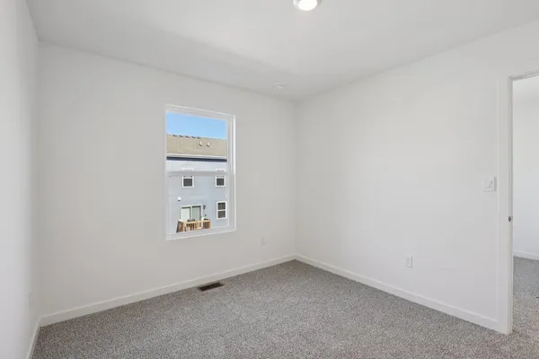 a view of an empty room and a window
