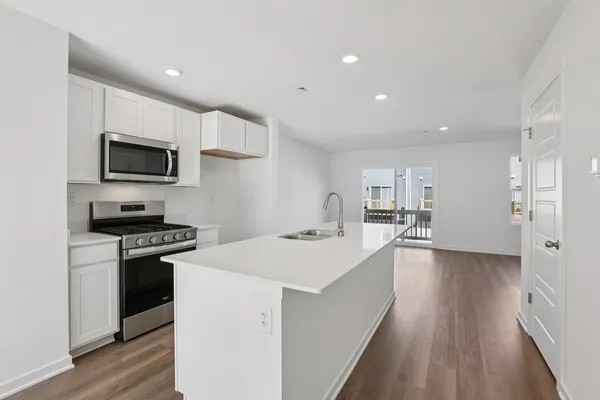 a kitchen with a stove a sink and a refrigerator