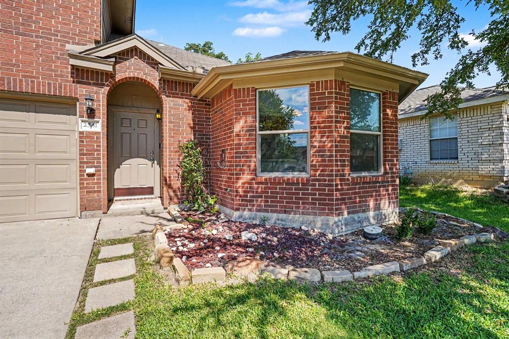 2541 Rivers Edge Drive Fort Worth, TX 76118 - Photo 2 of 31 a front view of a house with garden
