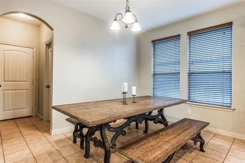 a view of a dining room with furniture and window
