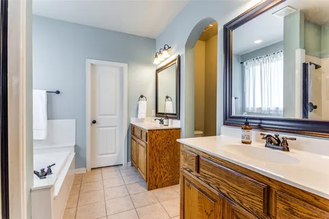 a white bath tub sitting in a bathroom next to a window