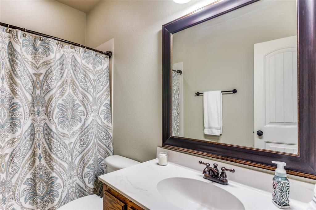 400 Commonwealth Drive Saginaw, TX 76179 - Photo 19 of 32 a bathroom with a sink and a mirror