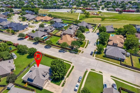 an aerial view of a houses with a swimming pool