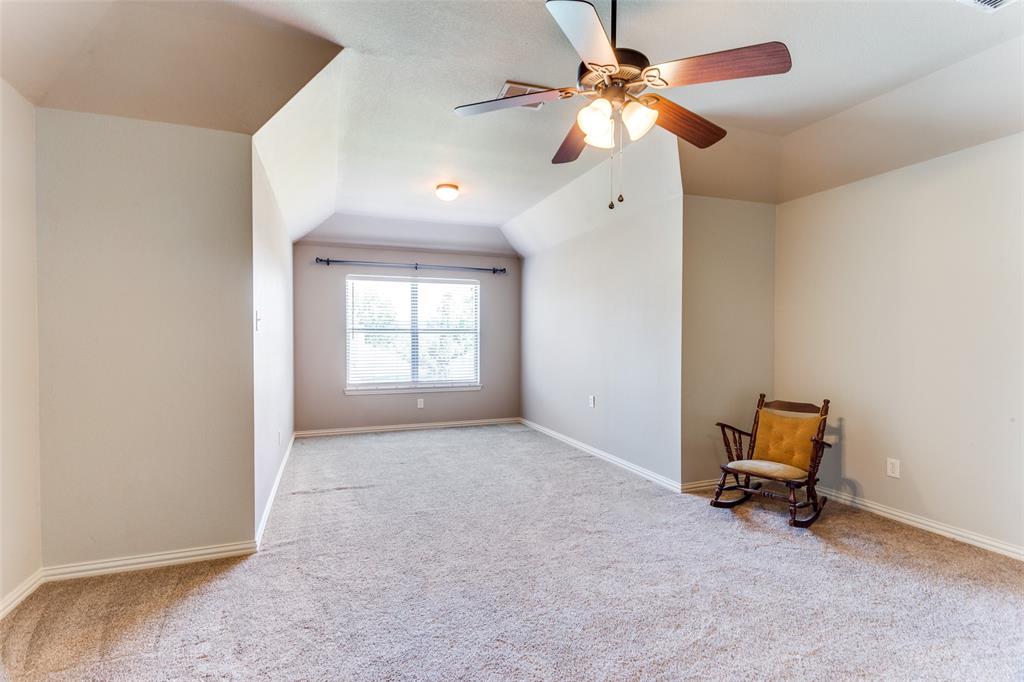 400 Commonwealth Drive Saginaw, TX 76179 - Photo 23 of 32 an empty room with windows and fan