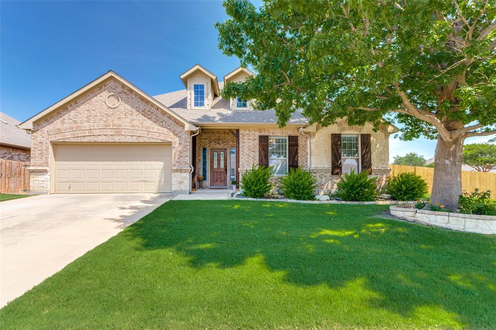 400 Commonwealth Drive Saginaw, TX 76179 - Photo 3 of 32 a front view of a house with garden