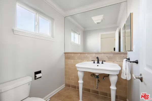 a bathroom with a sink a toilet and mirror