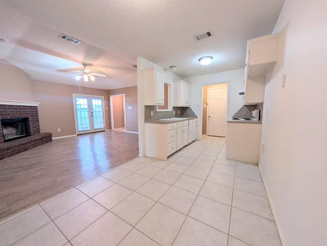 a kitchen with granite countertop a stove and a refrigerator