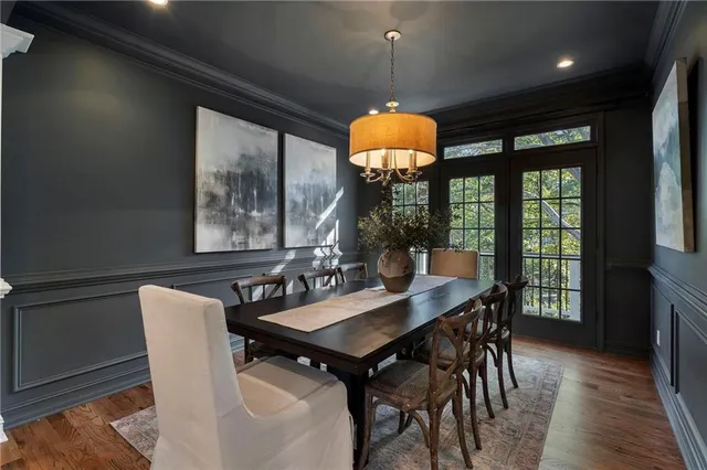 a living room with furniture a lamp and a potted plant