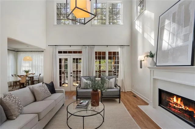 a kitchen with stainless steel appliances granite countertop a refrigerator a sink dishwasher and white countertops with wooden floor