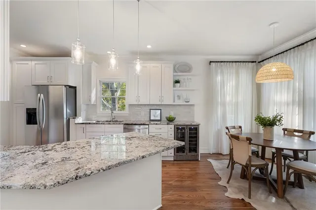 a kitchen with stainless steel appliances granite countertop a stove sink and cabinets