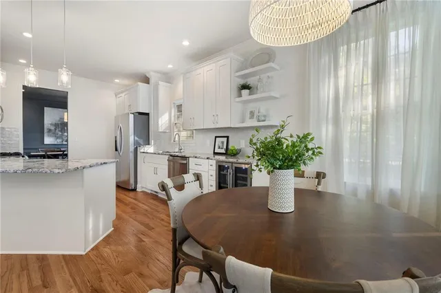 a kitchen with stainless steel appliances a refrigerator sink and cabinets