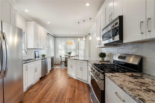 a bathroom with a double vanity sink toilet and shower