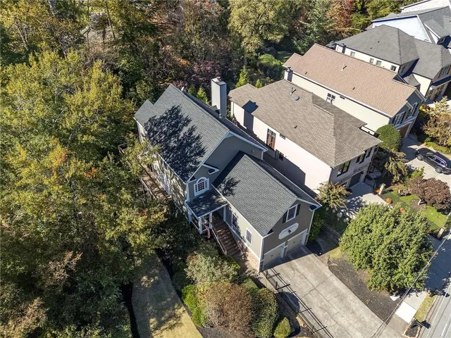 an aerial view of a house with garden space and street view