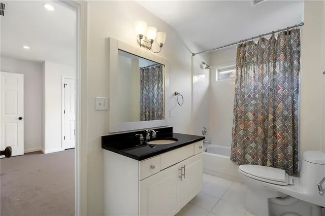 a bedroom with a bed lamp and a chandelier