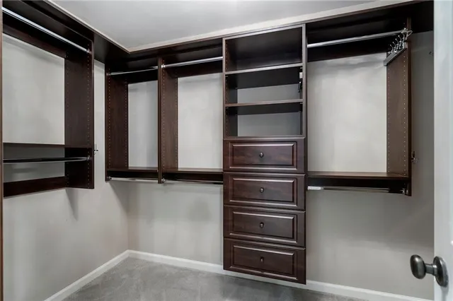 a view of an empty room with a fireplace and a window