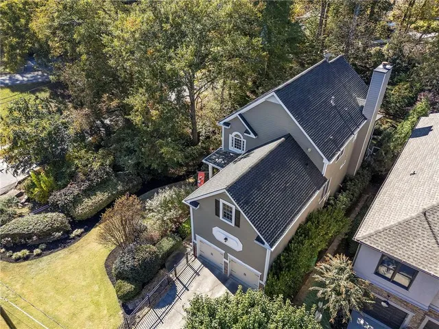 an aerial view of house with yard and mountain view in back