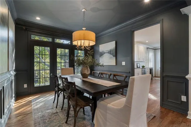 a view of a dining room with furniture wooden floor and chandelier