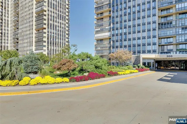 a view of building with a lot of flower plants