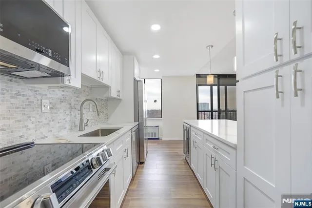 a kitchen with stainless steel appliances granite countertop a sink and stove