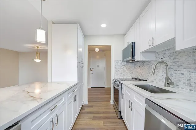 a large kitchen with a granite countertop sink