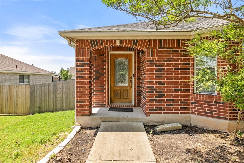 517 Castebar Drive Round Rock, TX 78664 - Photo 7 of 37 a front view of a house with a garden