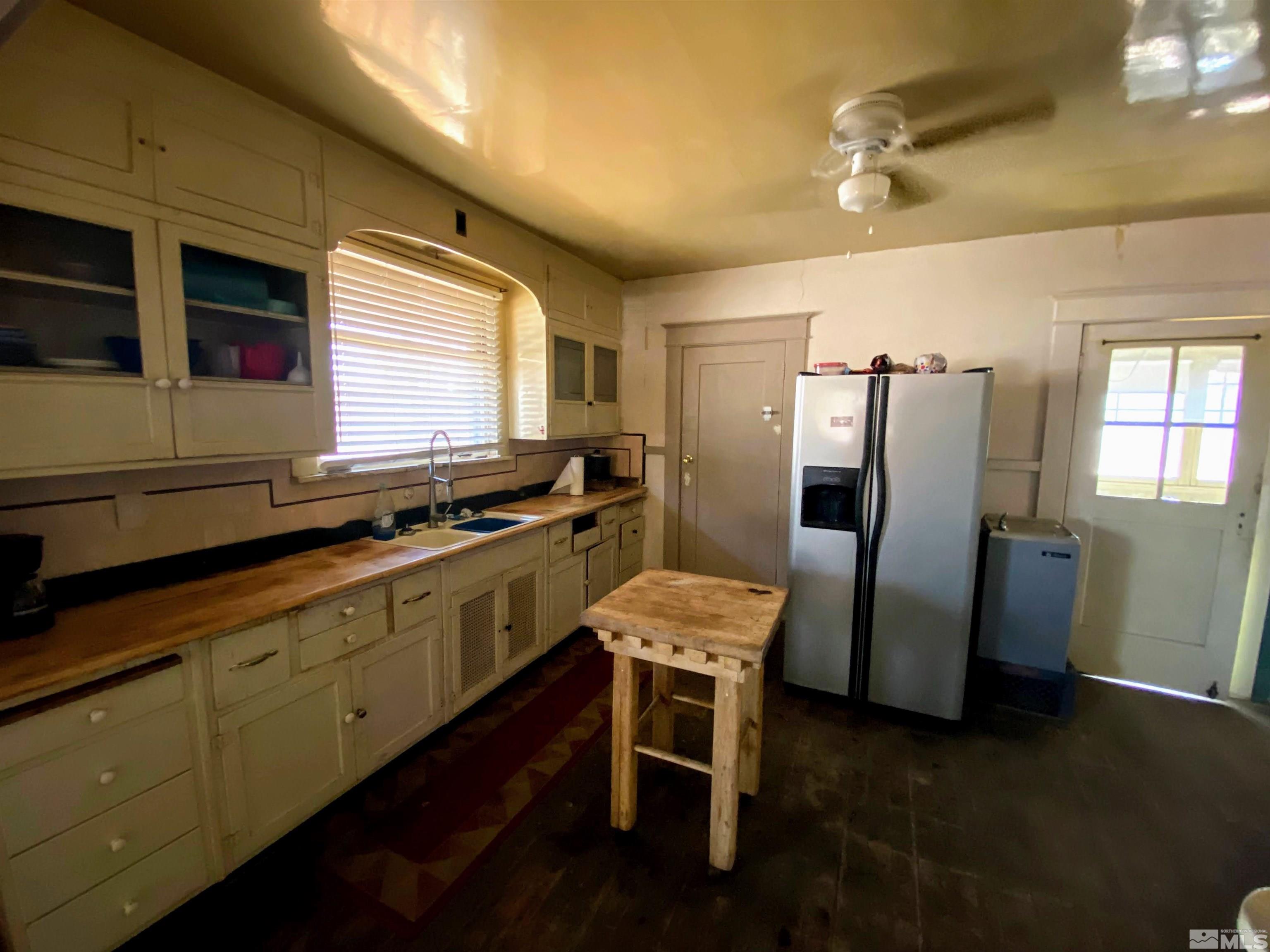 650 Spokane Street Reno, NV 89512 - Photo 10 of 25 a kitchen with a refrigerator and wooden cabinets
