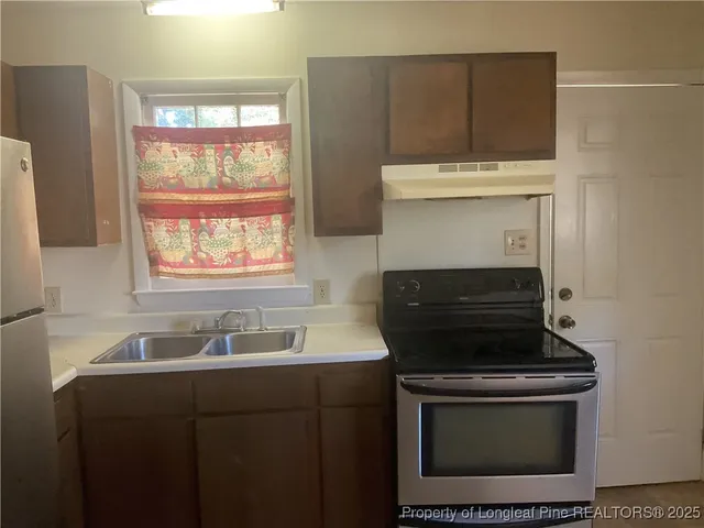 a kitchen with a stove and a sink