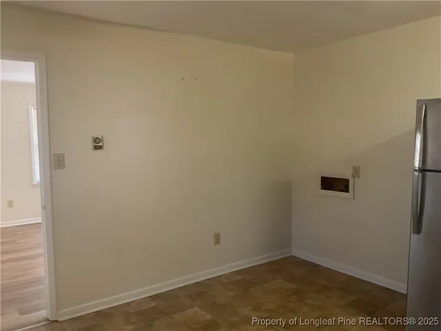 a kitchen with kitchen island a sink appliances and a window