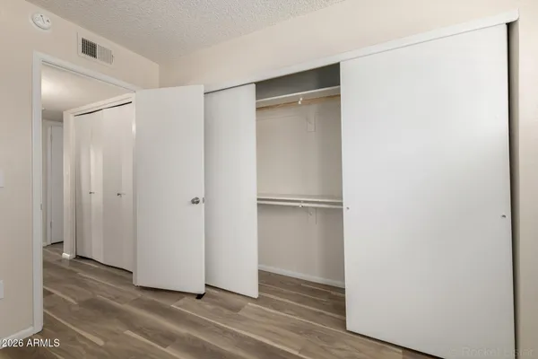 a bathroom with a granite countertop toilet sink and mirror