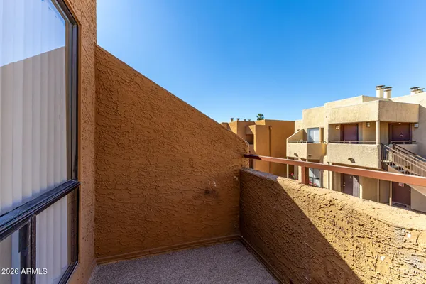 a bathroom with a granite countertop sink and a mirror with toilet