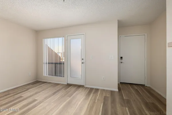 a view of empty room with wooden floor