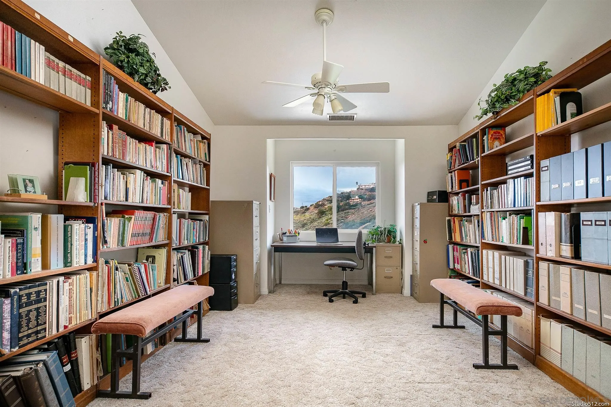 13190 Dermid Road Valley Center, CA 92082 - Photo 19 of 36 a view of a workspace with bookshelf and a book shelf